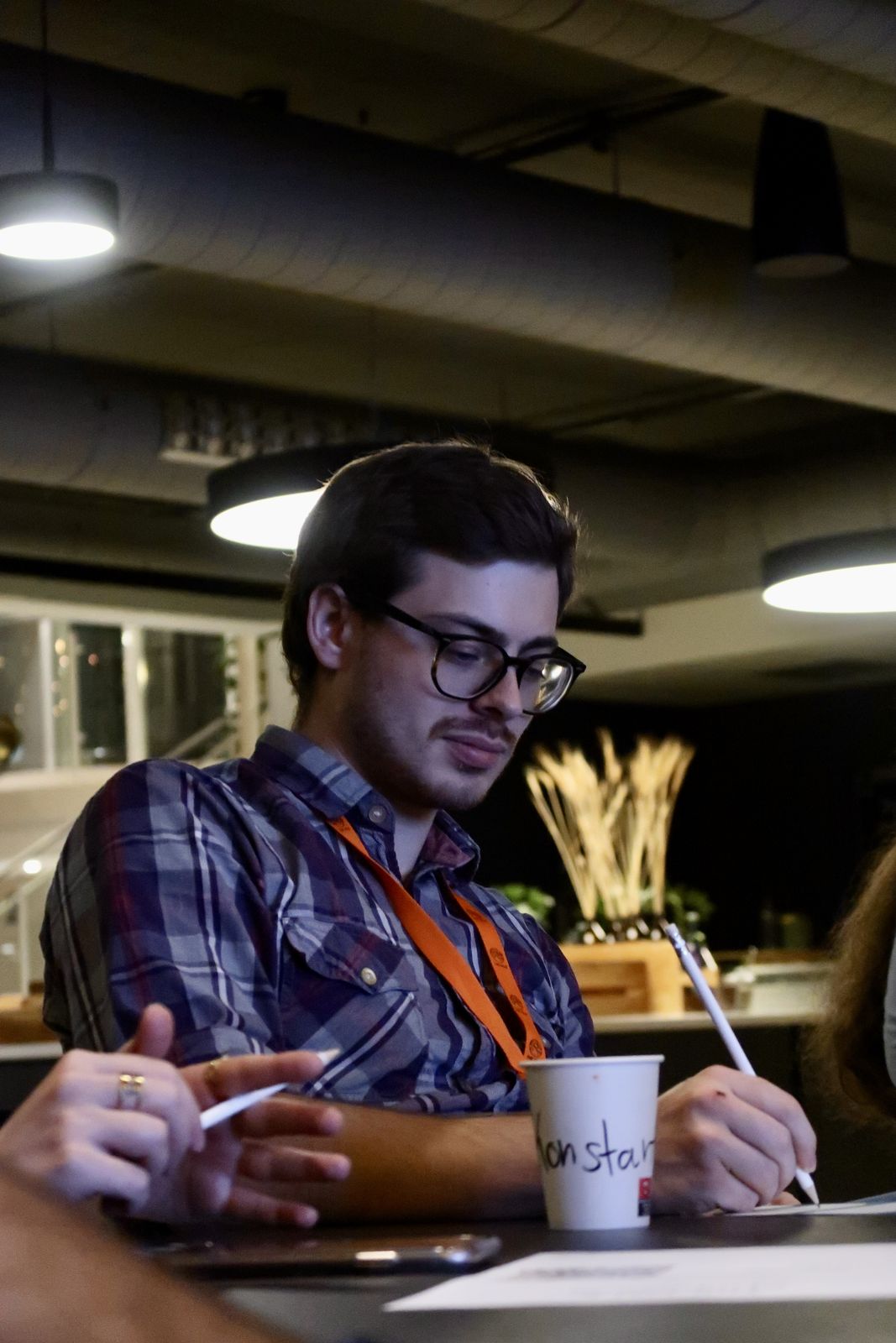 A participant writing quietly at a table